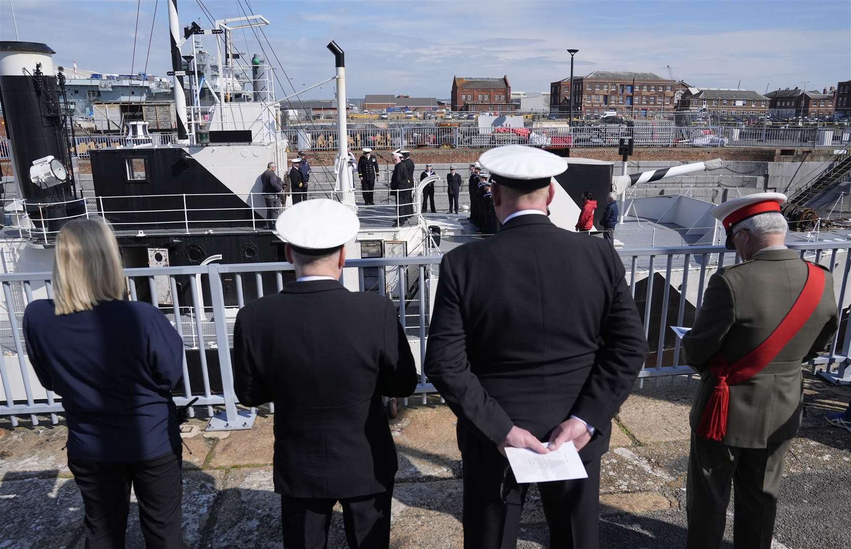 Members of the Royal Navy, Royal New Zealand Navy and Royal Australian Navy take part in an Anzac Day service of remembrance on board HMS M.33 at Portsmouth Historic Dockyard (Andrew Matthews/PA)