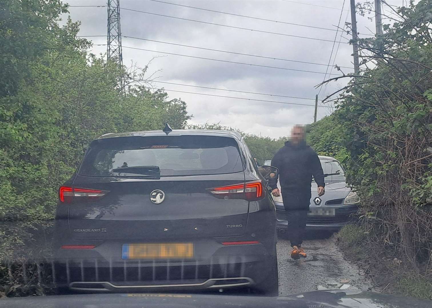 One man got out of his car to help vehicles pass along narrow Wraik Hill